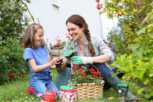 Gardener Richmond team working in eco-friendly garden area with recycling bins